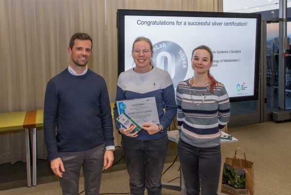 Vilhelmiina Haavaristo accepts the silver certificate for the Sauer/Zamboni lab.